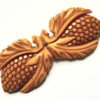 carved yellow bakelite brooch