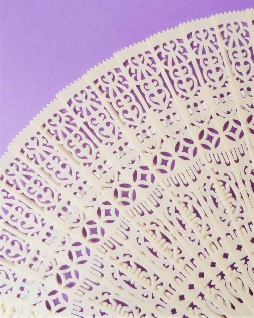 cream celluloid fan close up