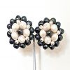 Monet pearls clip earrings on stand